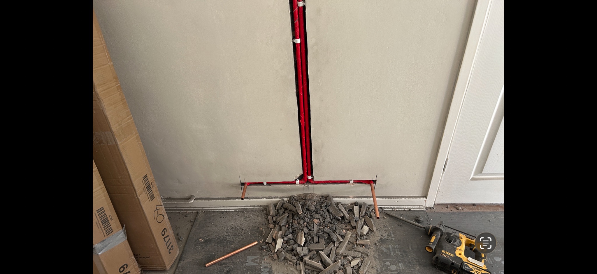 Radiator pipework chased into the wall during a designer radiator installation in Caerphilly